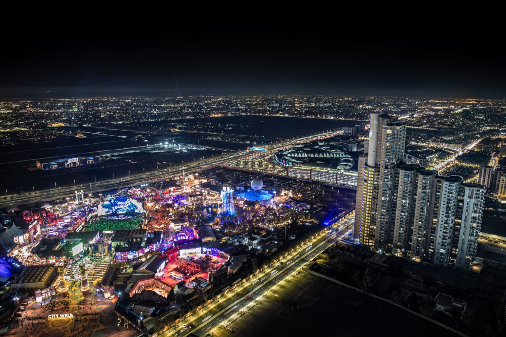 A stunning aerial view of a city at night with vibrant lights and tall buildings creating a mesmerizing skyline.